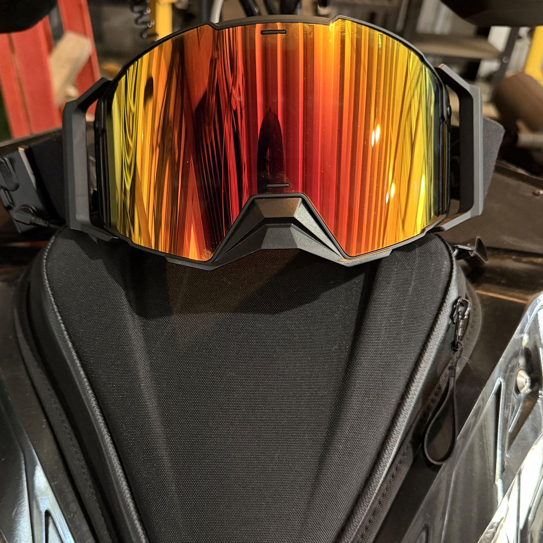 Hillarie heated snowmobile goggle on a snowmobile, front view #strap_top-secret-1