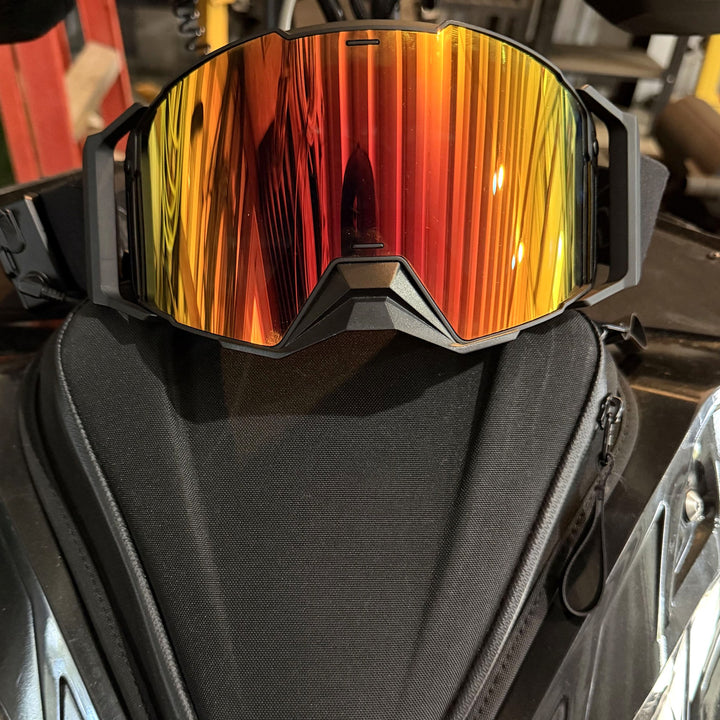 Hillarie heated snowmobile goggle on a snowmobile, front view #strap_top-secret-1